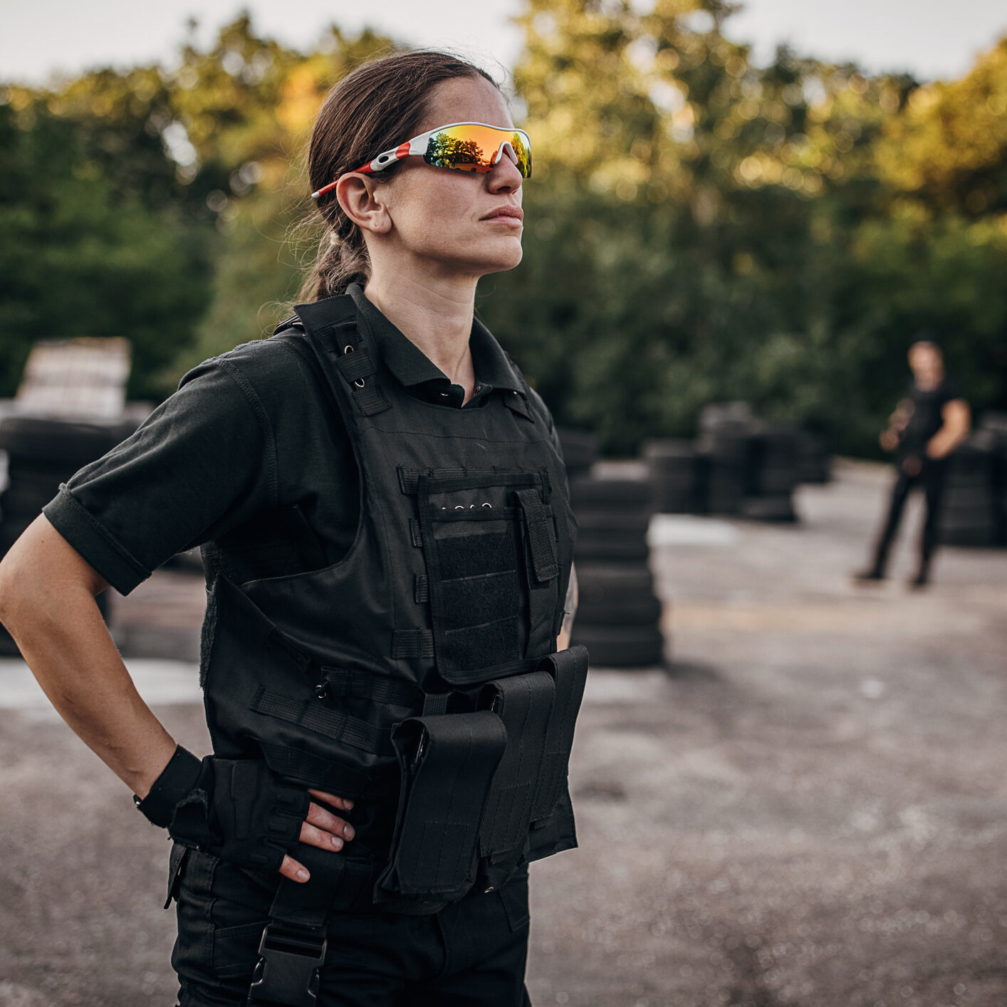 Woman in tactical vest and sunglasses