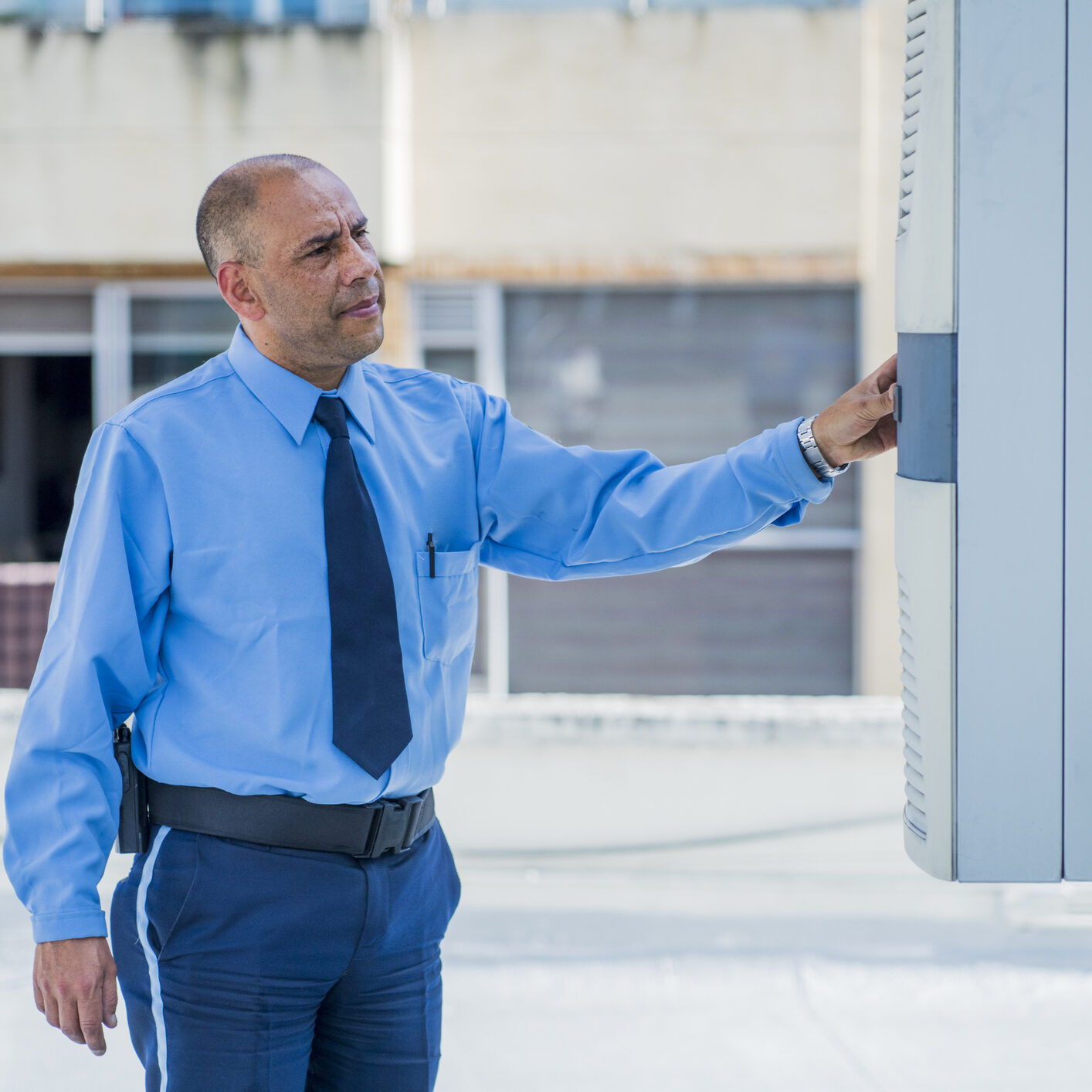 Individual in blue shirt at control panel