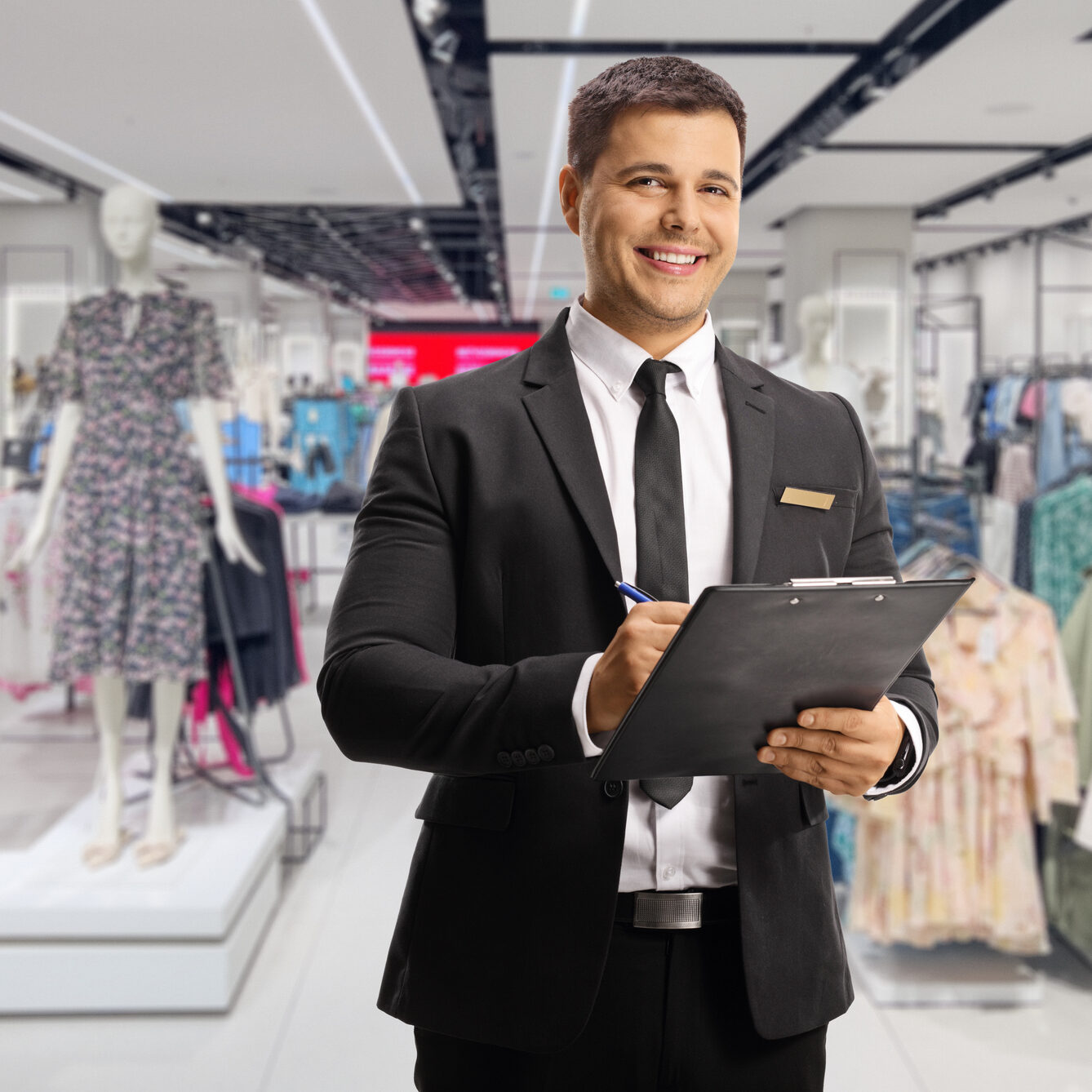 Retail employee smiling in fashion store