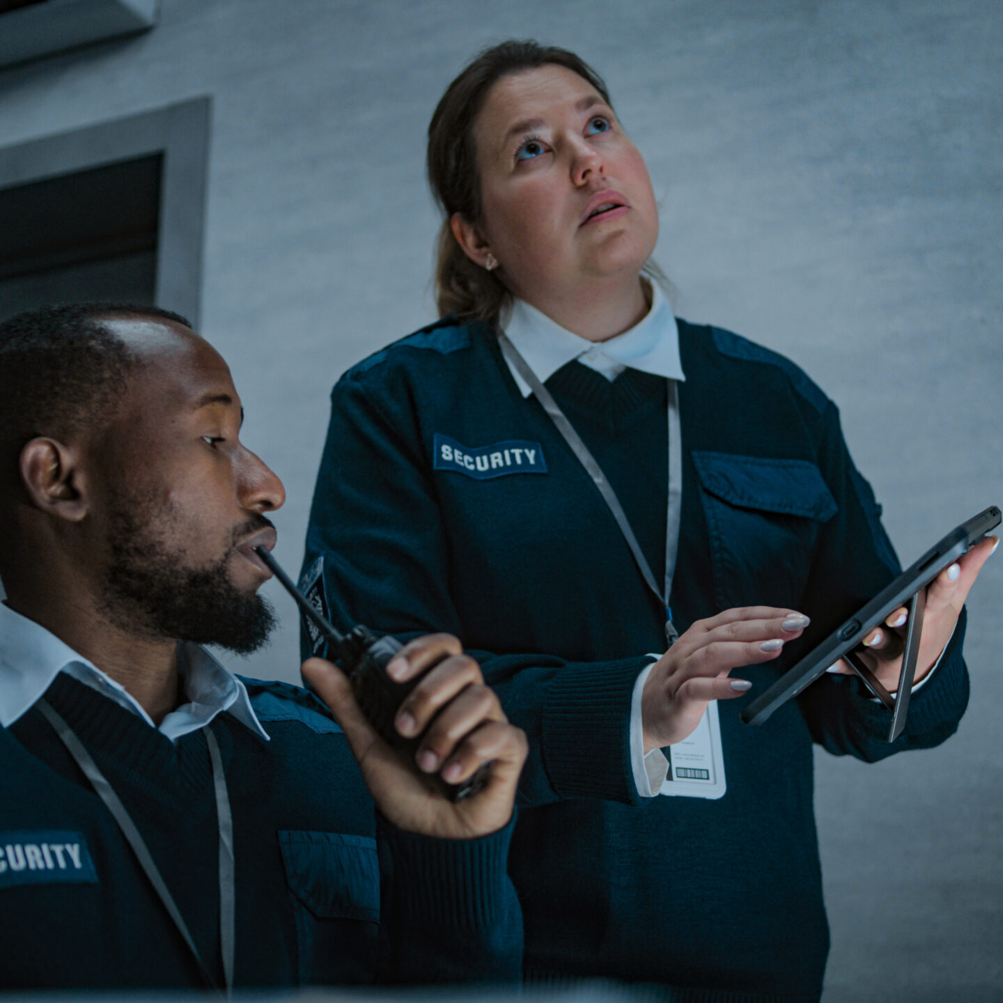Security team analyzing data on tablet