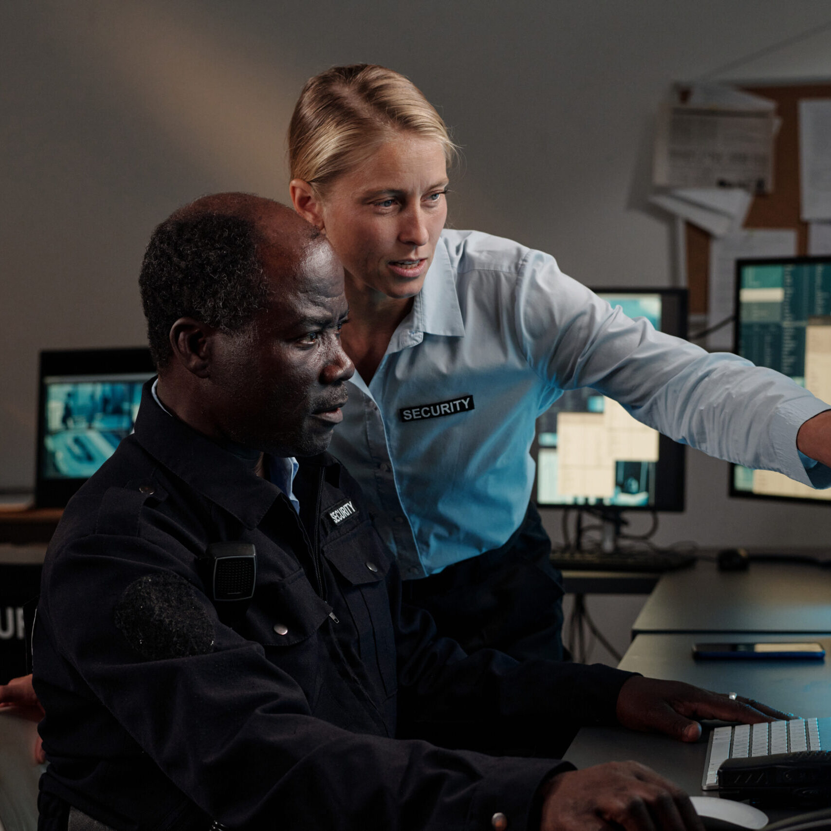 Colleagues discussing information on a monitor