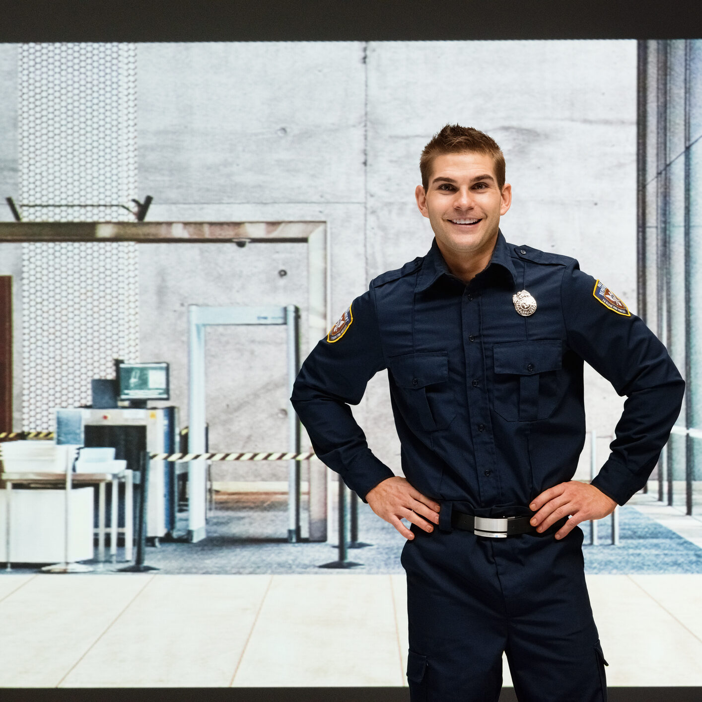 Officer posing in front of security checkpoint